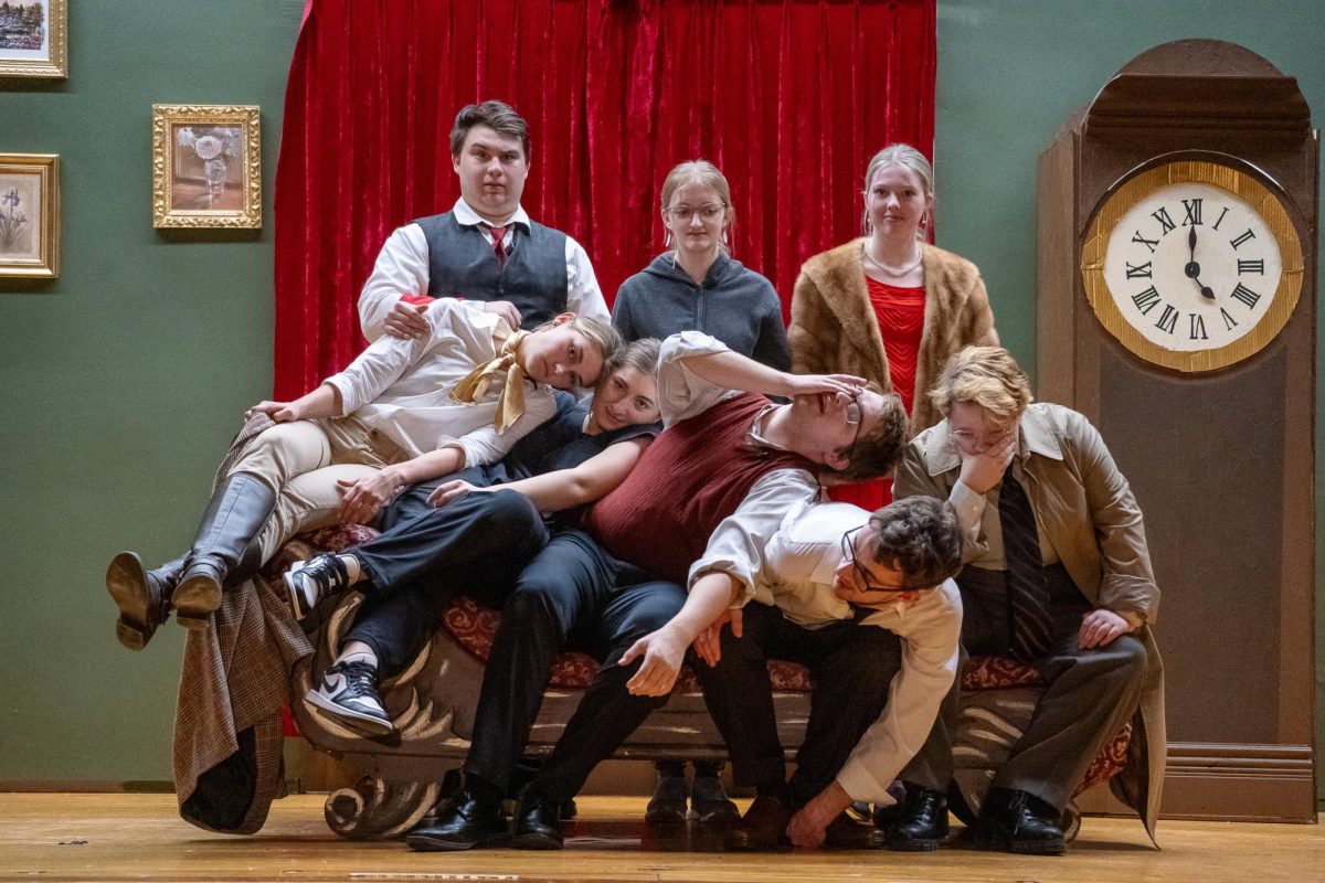 On-stage members of DCM Drama Club pose "in character" for the 2024 production of "The Play That Goes Wrong".