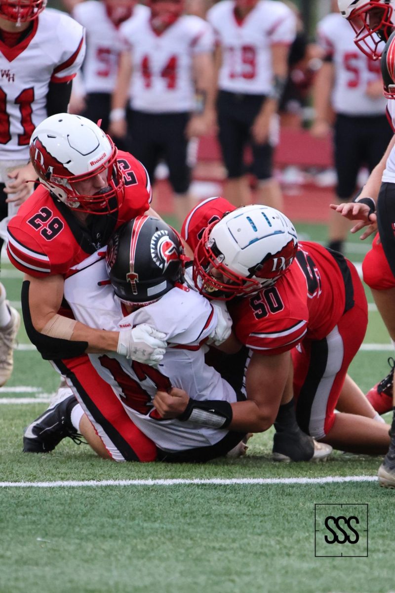 Wyatt Otto (SO) and Max Eccles (SR) tag team take down an opponent.